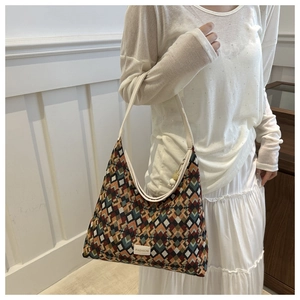 Detail shot of the bohemian woven bucket bag featuring colorful geometric patterns
