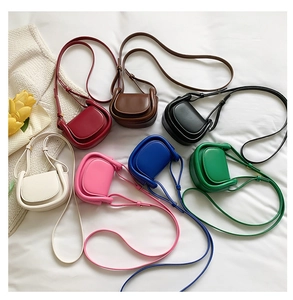 Detail display of mini saddle bags in seven colors on a soft white fabric background