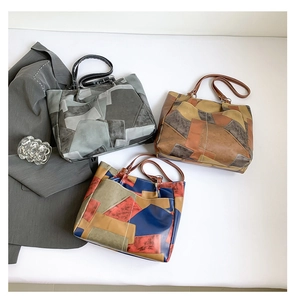 Flat lay detail showing multi-color patchwork leather tote bags with geometric designs