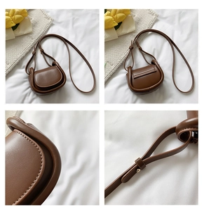 Detail view of brown matte leather mini crossbody bag with adjustable strap and flap closure