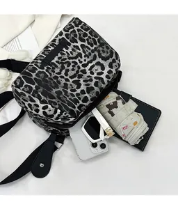 Spacious interior of leopard print canvas crossbody bag showing daily essentials