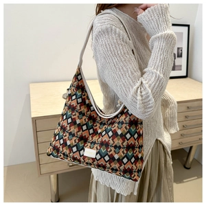 Detailed close-up of retro geometric patchwork woven fabric and beige leather trim strap