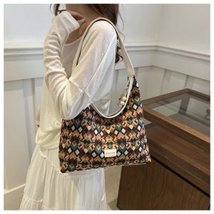 Detailed view of colorful geometric pattern nylon tote bag with white leather strap