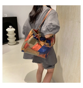 Large color-block tote bag with geometric patchwork shown as shoulder bag style
