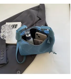 Vue intérieure du sac cylindrique en jean bleu montrant un espace de rangement spacieux