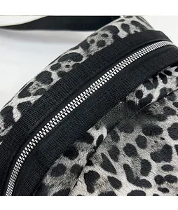 Detail of leopard print shell bag featuring high-quality silver metal zipper and fabric trim