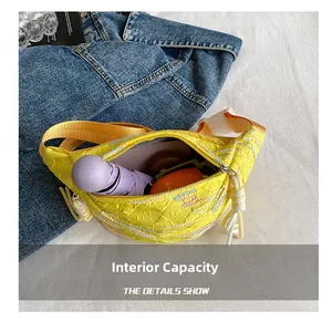 Detailed interior view of a yellow quilted chest bag showing large storage capacity