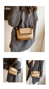 Detail of woven straw shoulder bag with brown leather trim and knot strap detail