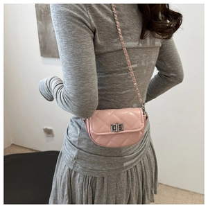 Detailed back view of pink quilted leather mini crossbody bag with silver chain strap