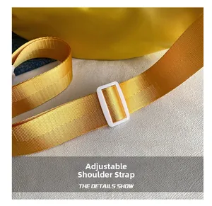 Macro detail of adjustable bright yellow woven nylon shoulder strap with white plastic buckle