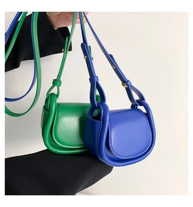 Detail of micro saddle crossbody bags in green and blue with glossy finish