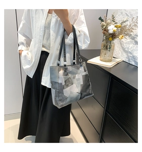 Detail of artistic geometric color block tote bag with elegant long leather shoulder straps