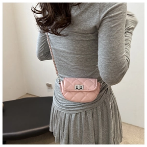 Detail of pink quilted mini crossbody bag with silver twist lock and chain strap