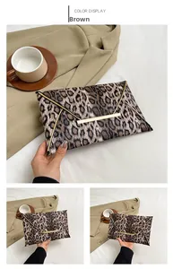 Leopard print envelope clutch featuring gold metal trim and protective corner accents