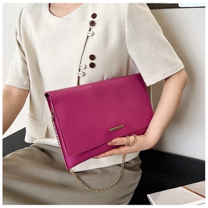 Chic fuchsia envelope clutch with gold chain strap and sleek metal bar detail