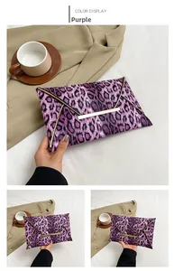Close-up of purple leopard print envelope clutch featuring stylish gold metal trim detail