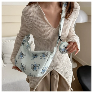 Detail of blue floral corduroy crescent bag with matching round coin purse accessory