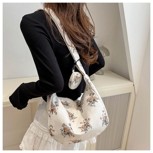 Detail of floral corduroy dumpling bag with matching small round coin purse on strap