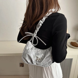 Silver metallic pleated shoulder bag with butterfly charm and cloud-like ruffled strap