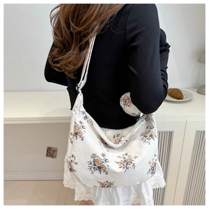 Floral hobo shoulder bag in white corduroy with adjustable strap and small round pouch
