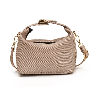 Chic beige crossbody bag with twill texture and gold metal handles for summer 2025