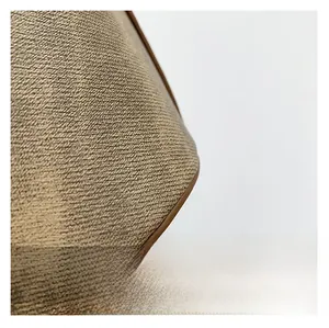 Macro view of woven fabric texture with brown leather edge on retro bucket bag