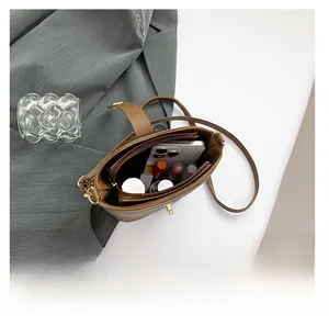 Interior view showing the large capacity of this brown leather bucket bag for daily essentials