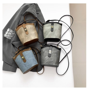 Detail showing vintage bucket bags in four colors with turn-lock and contrast piping