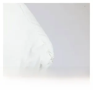 Detailed close-up of quilted white puffer fabric with reinforced stitching and soft padding