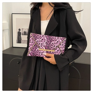 Close-up of purple leopard print envelope clutch bag with elegant gold metal trim and lock