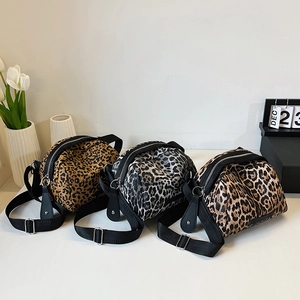 Three leopard print shell bags in brown, grey and tan with adjustable fabric straps
