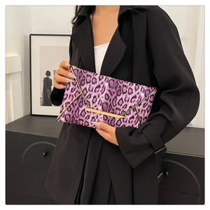 Close-up of a purple leopard print cotton clutch bag with gold metallic trim for women