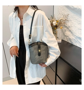 Detail view of a vintage bucket bag with contrast stitching and gold turn-lock closure
