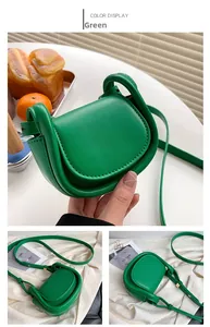 Detail view of mini green semi-circle crossbody bag with adjustable shoulder strap