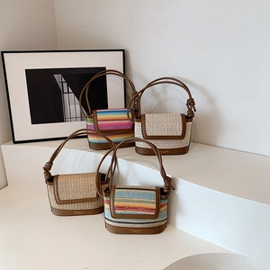 Assorted woven stripe shoulder bags with leather base and knot strap on display