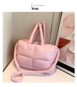 Detail of pink quilted puffer tote bag with soft padded handles and nylon texture