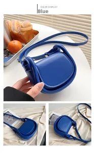 Detailed view of the mini blue leather handbag showing high-quality stitching and texture