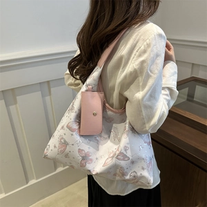 Large tote bag with pink butterfly prints and a matching small coin purse for women