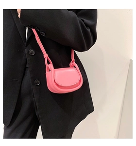 Detail of pink mini semi-circle crossbody bag with matte leather and fine strap