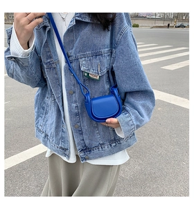 Detail view of a bright royal blue mini crossbody bag in leather for kids