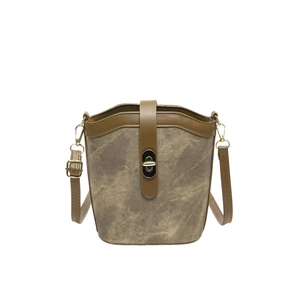 Retro canvas bucket bag with contrast leather trim and golden twist lock on white background