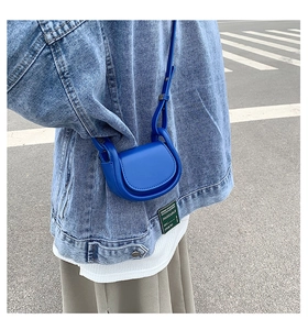 Close-up of klein blue crossbody saddle bag styled with denim for a trendy kids outfit