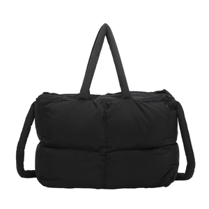 Large black quilted puffer tote bag with padded handles and adjustable shoulder strap