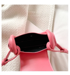 Top view of bright pink mini bag opening with black interior lining and card slots