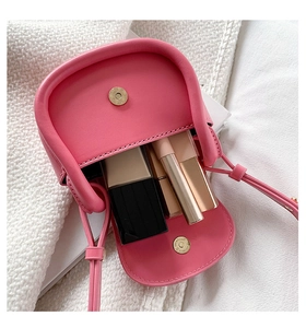 Interior view of pink leather mini crossbody bag showing lipstick storage capacity