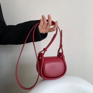 Minimalist red leather half-round crossbody bag with golden hardware for children