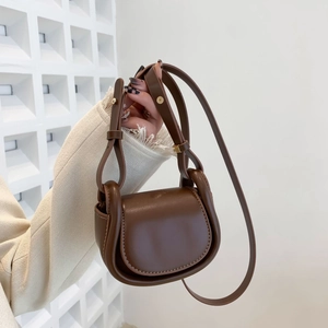 Vintage brown matte leather saddle bag for kids with gold hardware and shoulder strap