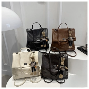 Detail shot of four vintage leather backpacks in black, brown, cream, and dark coffee colors