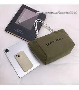 Olive green canvas tote bag capacity comparison with tablet and smartphone devices