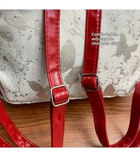 Detail of adjustable red leather shoulder strap on butterfly print women backpack